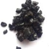 Pure Himalayan shilajit resin jar with measuring spoon on natural stone background